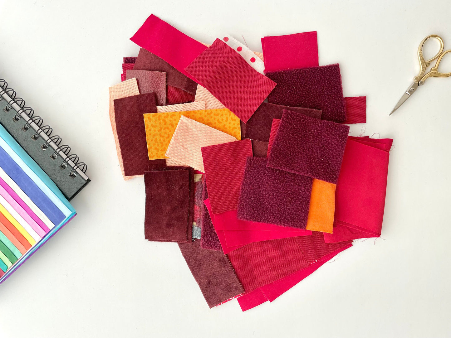 red and orange small square fabric scraps in various sizes. Fabric pieces for craft box supplies, slow stitching and crumb quilting.