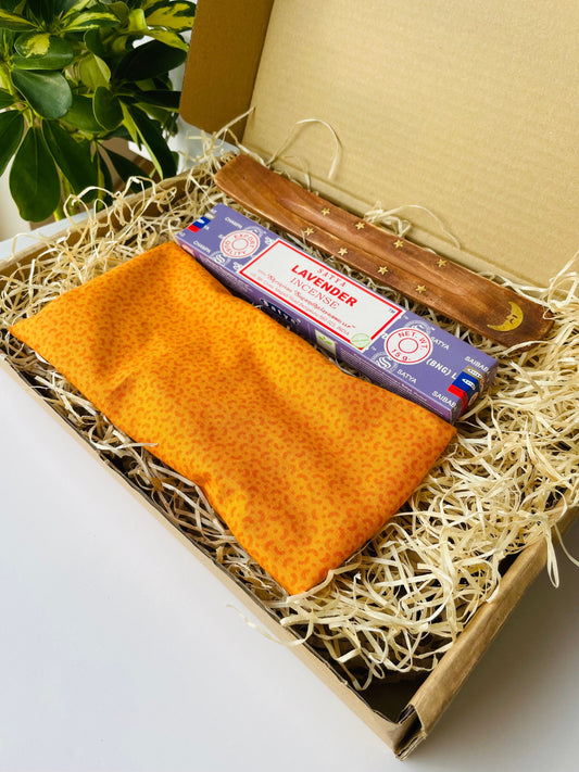 Relaxation and yoga gift box with handmade orange weighted eye pillow and lavender satya incense presented in an eco friendly cardboard gift box.