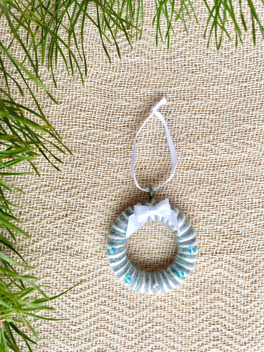 Upcycled holiday decor a circular mini wreath made with blue, grey and white wool, handmade in Ireland.