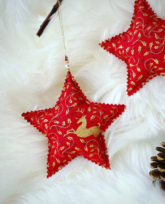 Red Star shape fabric christmas decoration with a gold deer and holly pattern. Handmade in Ireland. Finished with glass beads.