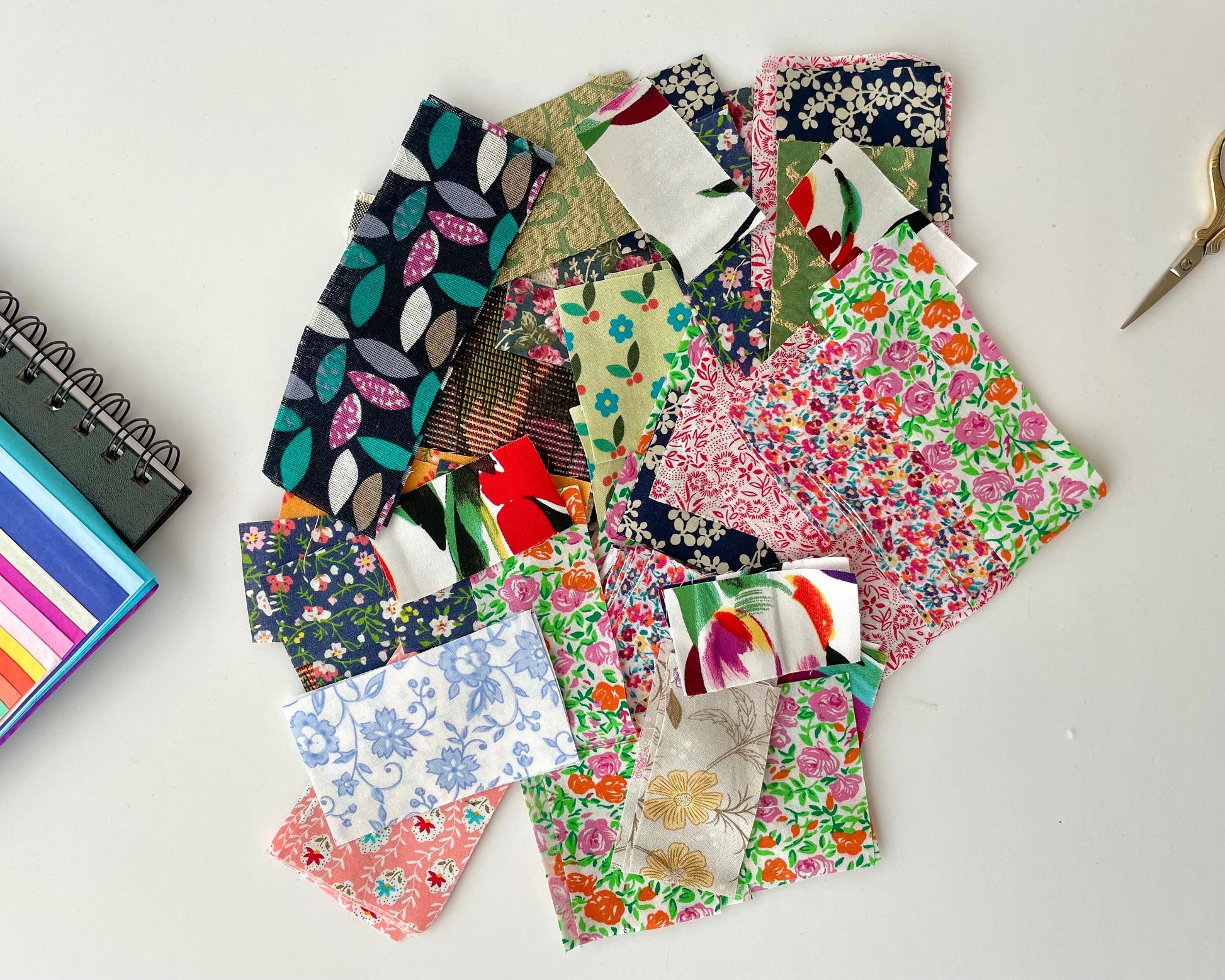 various Floral  and botanical print fabric scraps for crafting in a mix of colours, cut into small rectangular shapes. Use for craft supplies, kids collages, slow stitching