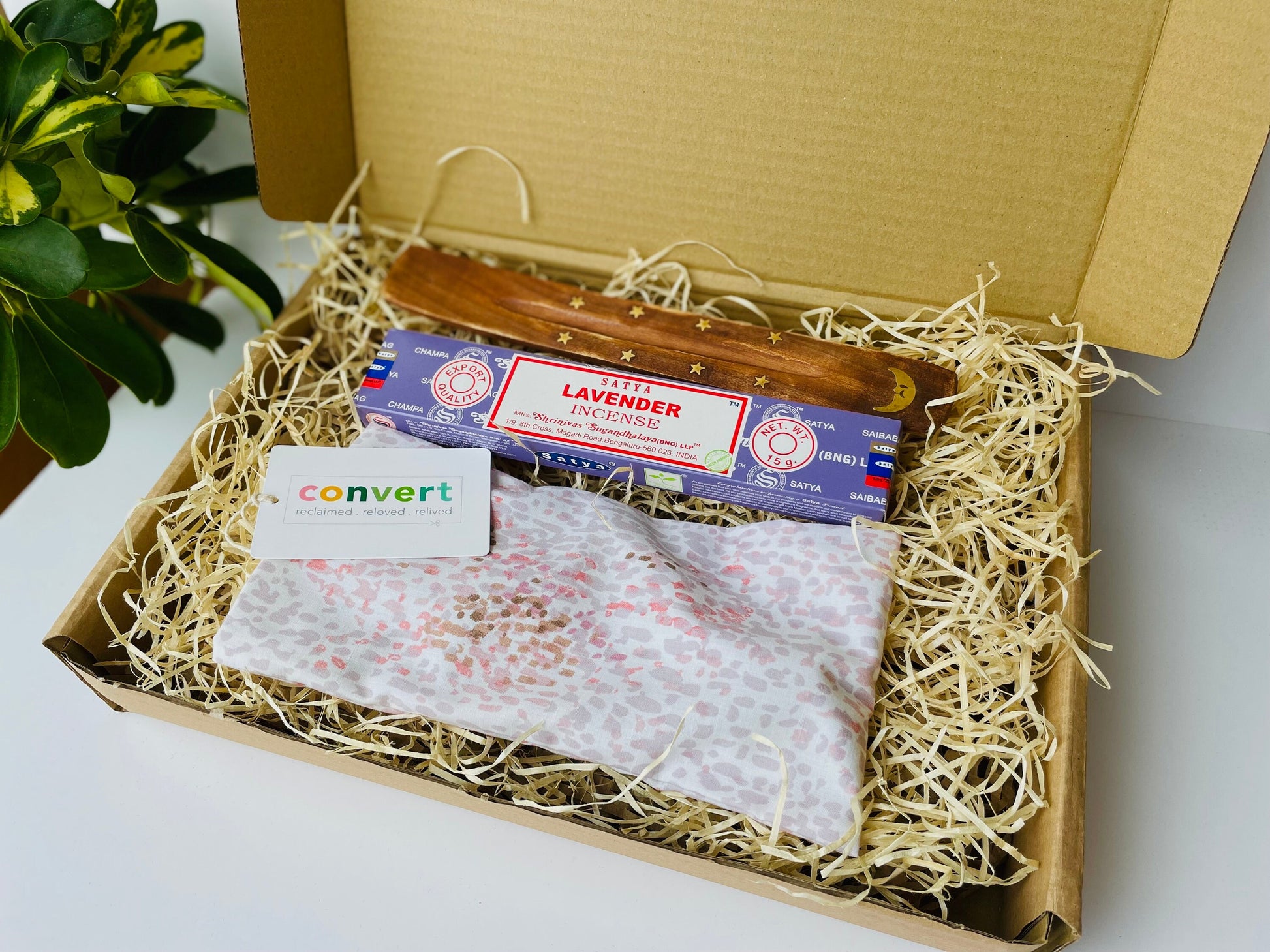 Yoga gift set featuring an upcycled pink weighted eye pillow, satya lavender incense and wooden incense holder, gift boxed in cardboard with wood wool.