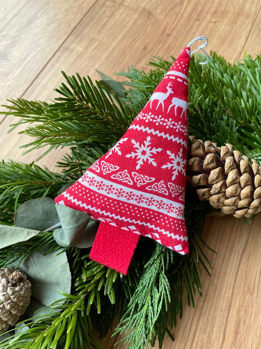 Handmade holiday decor red fabric Christmas tree shape ornament with a white scandi pattern 