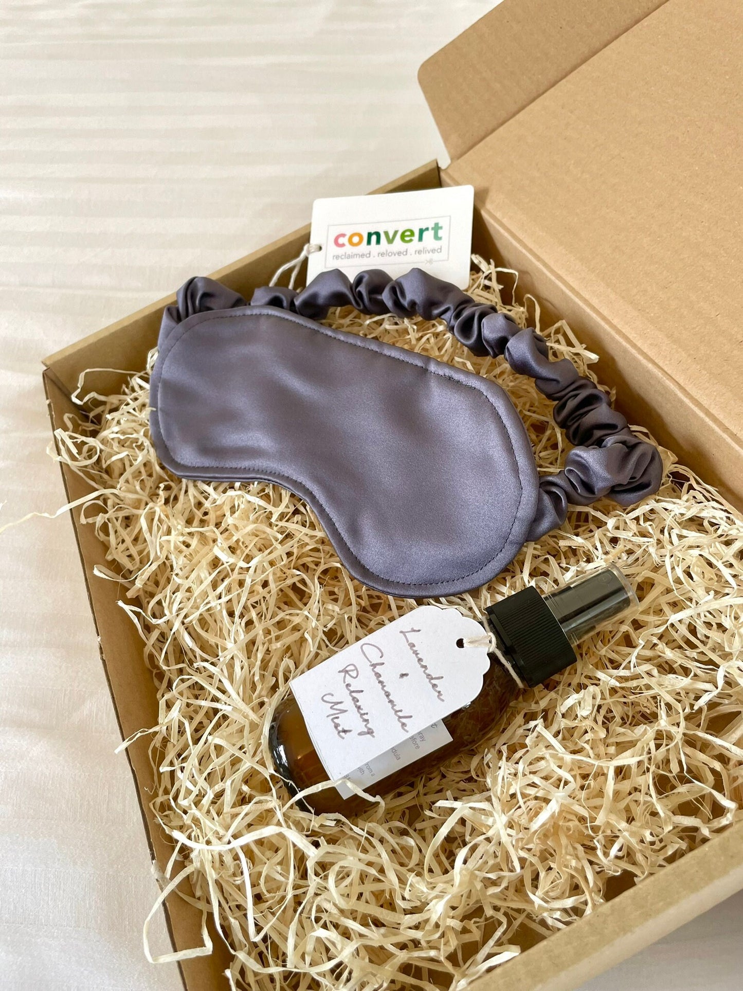 Handmade sleep gift hamper with an upcycled grey satin eye mask and hand blended lavender and chamomile room spray. 100% compostable gift packaging and vegan friendly.