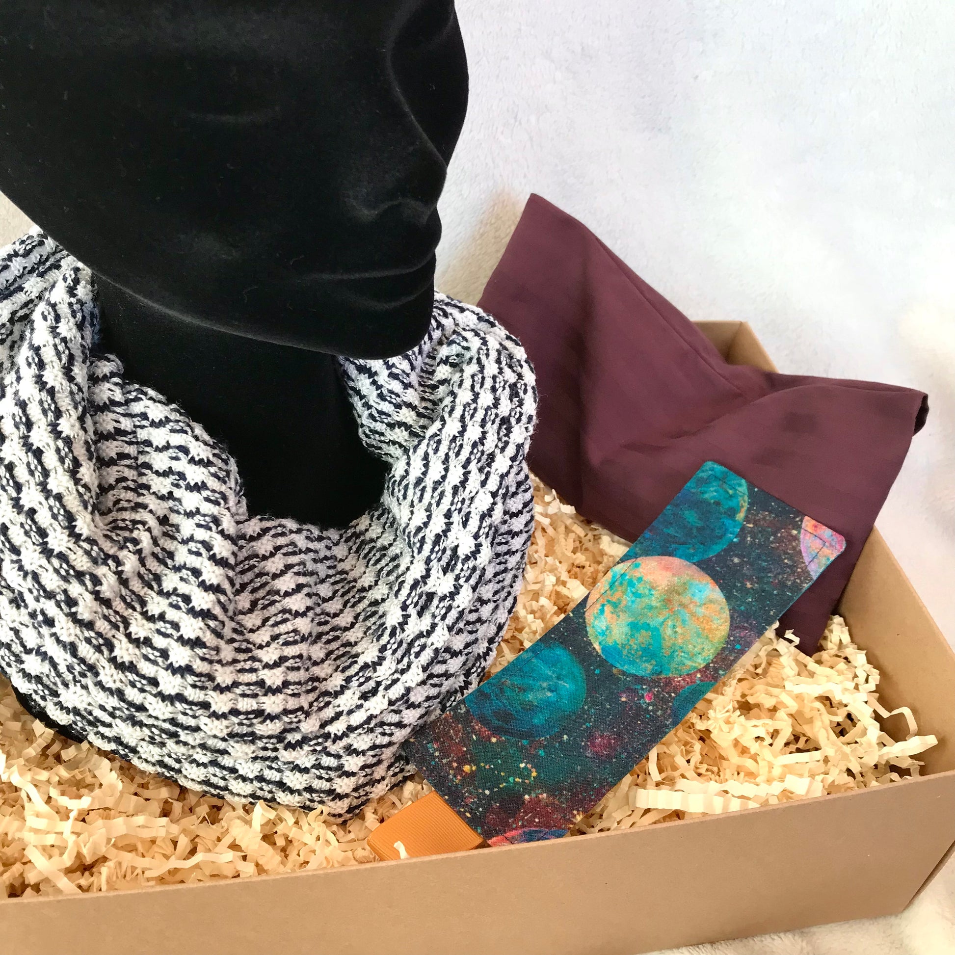 Boxed gift set containing snood scarf, burgundy weighted eye pillow and a galaxy theme bookmark, all handmade with upcycled fabrics.