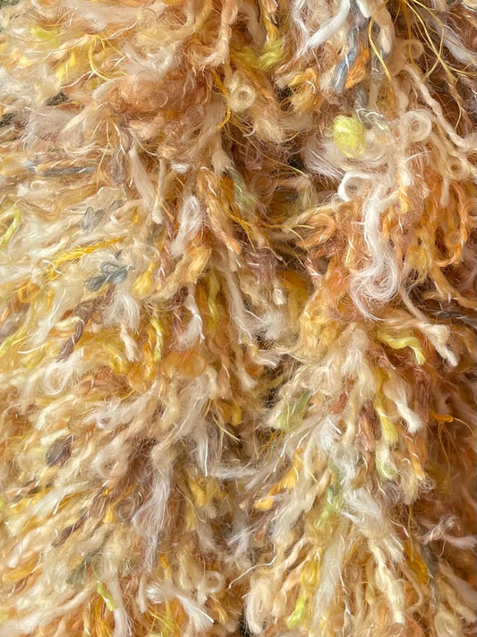 Yellow and gold wool eco friendly handmade tinsel close up. Sustainable Christmas decoration made in Ireland.