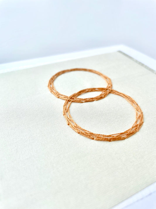 Wedding day greetings card hand embroidered with two gold rings on an ivory background. Handmade in Ireland.